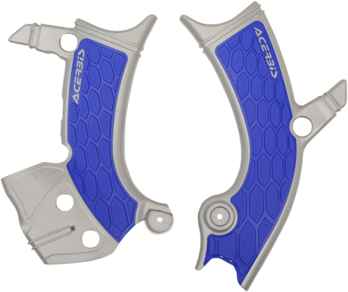 Acerbis X-Grip frame guards in silver and blue installed on a motorcycle body, providing protection and style.