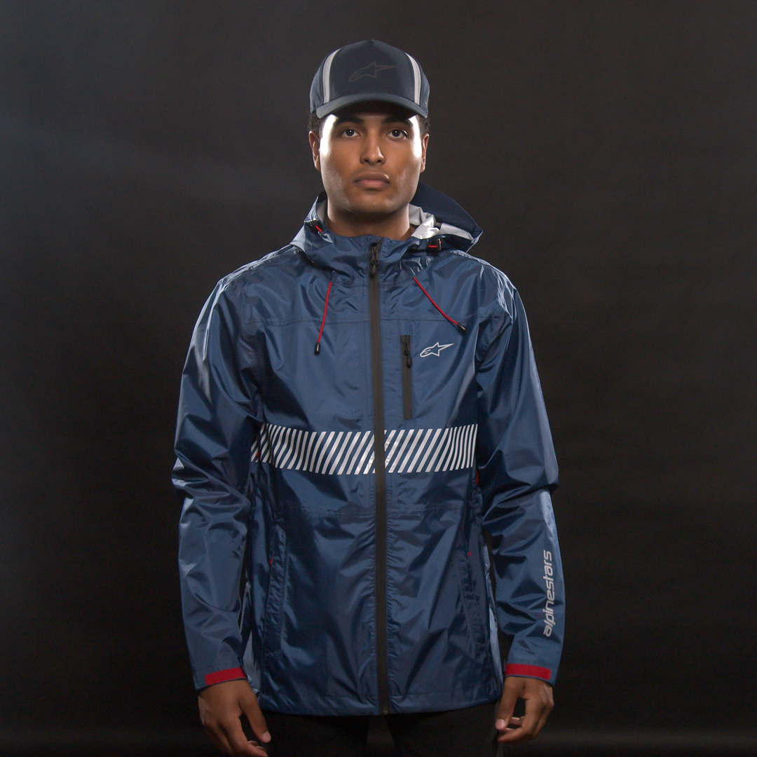 Alpinestars Fusion Rain Jacket in navy, medium size, shown on a hanger with waterproof fabric and reflective details.