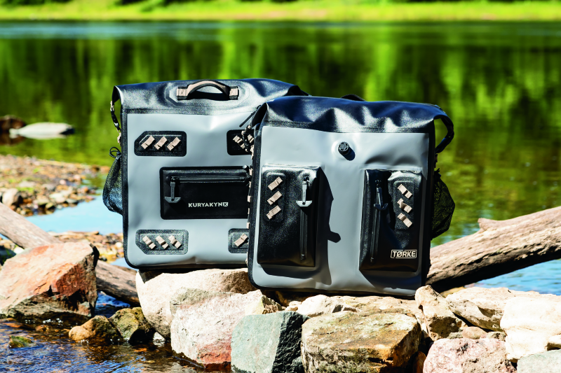 Kuryakyn Torke 24L waterproof dry bag panniers for power sports storage, shown mounted on motorcycle with secure straps.