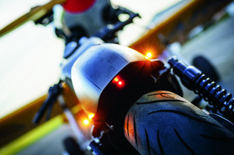 Kuryakyn Kellerman Atto smoke lens red run-brake light showing compact design and red lens for motorcycle lighting.
