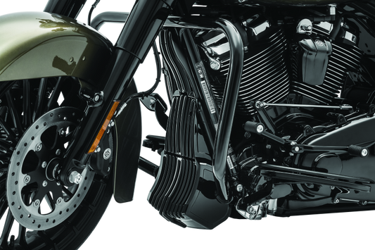 Black Kuryakyn oil cooler cover for Harley Davidson Touring models, part #6418, shown installed on motorcycle engine area.