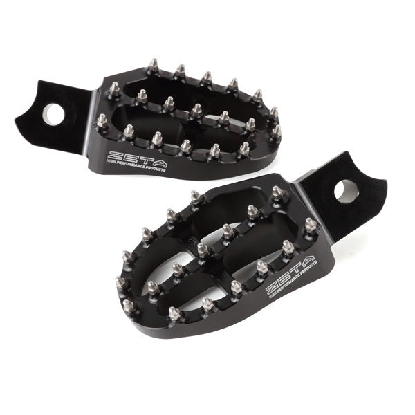 Black aluminum ZETA footpegs for motocross bikes, part number ZE93-1100, showing close-up of textured footrest surface and mounting points.