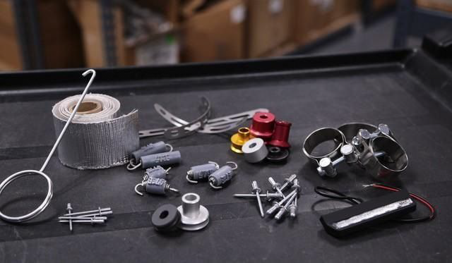 YOSHIMURA RS9T muffler badge, authentic OEM emblem for motorcycle exhausts, silver and black logo on metallic surface