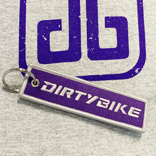 eDirtyBike key chain featuring a durable metal design with the DirtyBike logo, ideal for attaching to keys or bags.