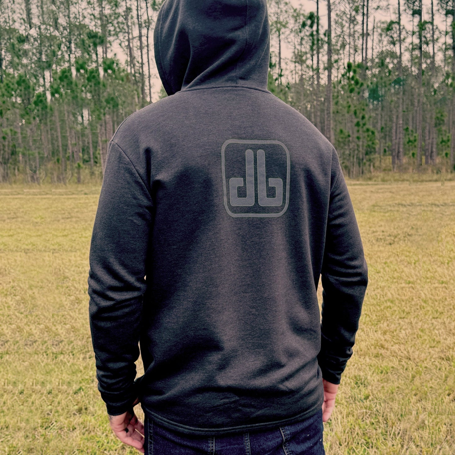 Back view of black eDirtyBike hoodie shirt with logo print on the back, casual streetwear style.