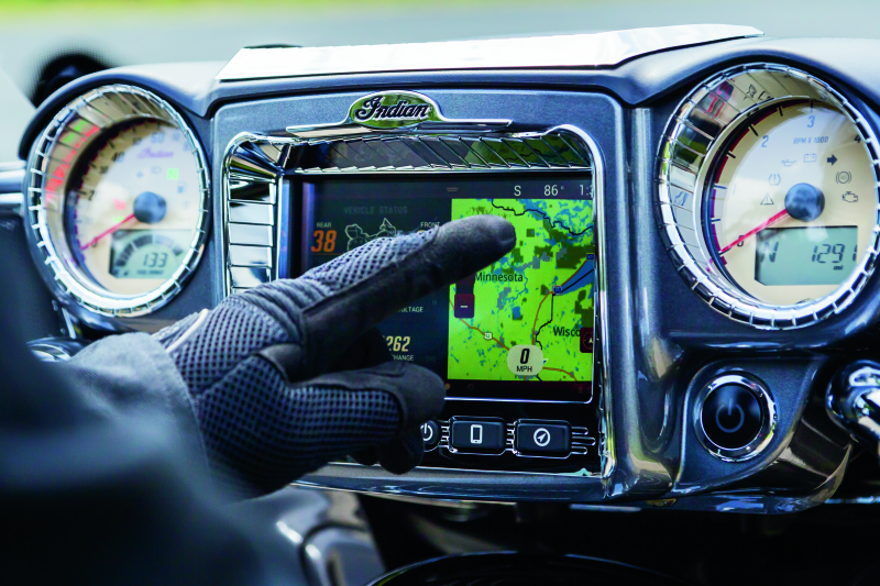 Kuryakyn Aztec gauge accent in chrome on Indian motorcycle dashboard, featuring intricate Aztec design for 2014-2023 models.