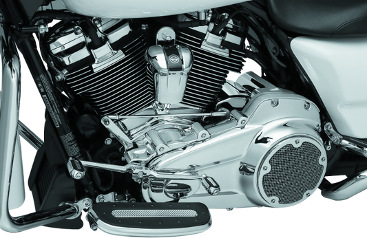 Kuryakyn chrome inner primary cover for Harley Davidson Touring models, showcasing polished finish and detailed design.