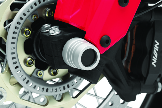 Kuryakyn front axle slide for Honda CRF1000L Africa Twin and Adventure Sports models, part #3826, shown on motorcycle axle.