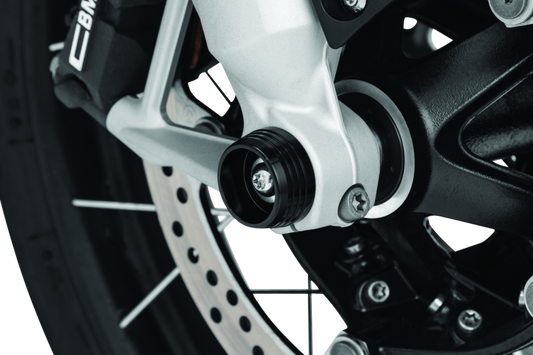 Kuryakyn Lodestar front axle sliders installed on BMW R1200GS and RT motorcycle models, showing protective gear for the front axle.