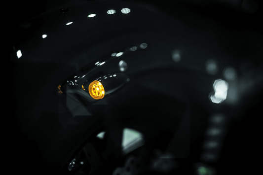 Kuryakyn Super Bright LED Mini Bullet Lights in Amber, gloss black finish, for motorcycle lighting accessories.
