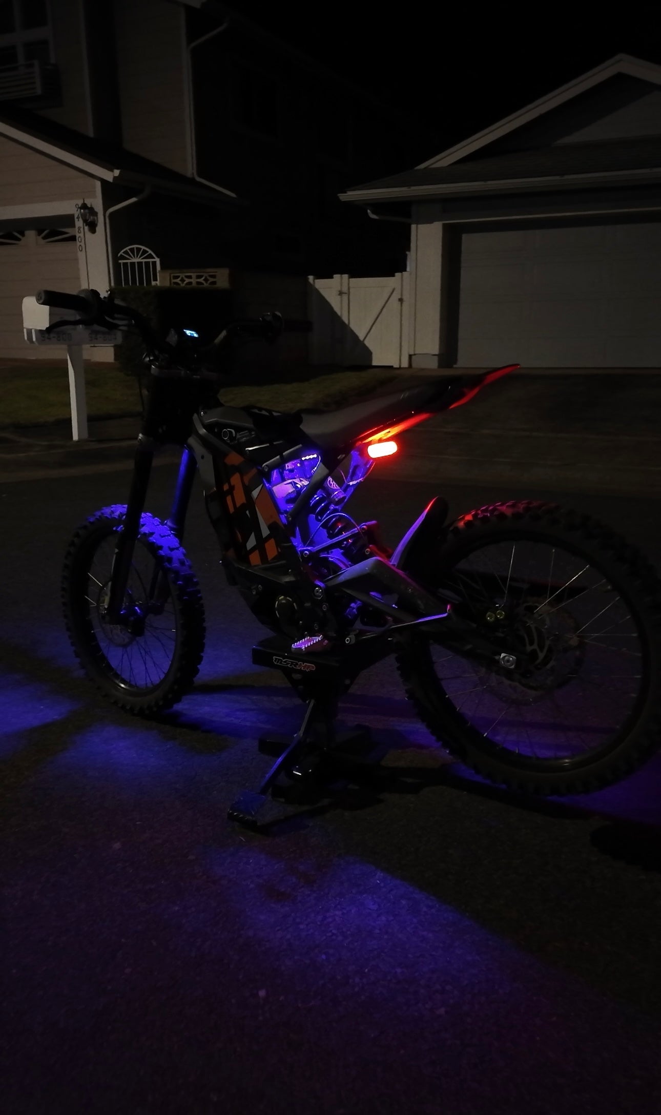 Purple rear underglow kit for Surron Light Bee by Project9, illuminating the underside of the electric dirt bike.