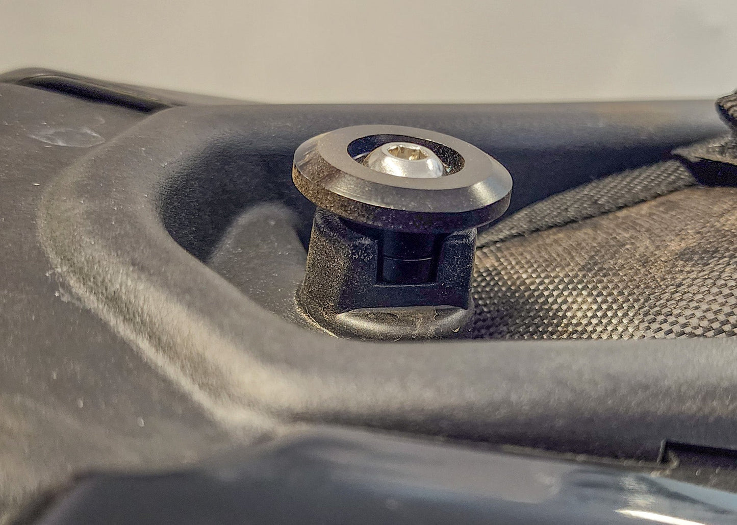 Warp9Racing Ultra Bee seat spacer installed on a bike seat catch for improved fit and stability.