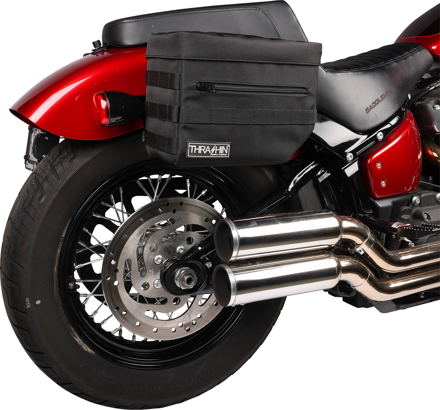 Black THRASHIN SUPPLY CO. Essential Saddlebags TSB-0006 with 10-liter storage capacity, shown on motorcycle with secure straps.