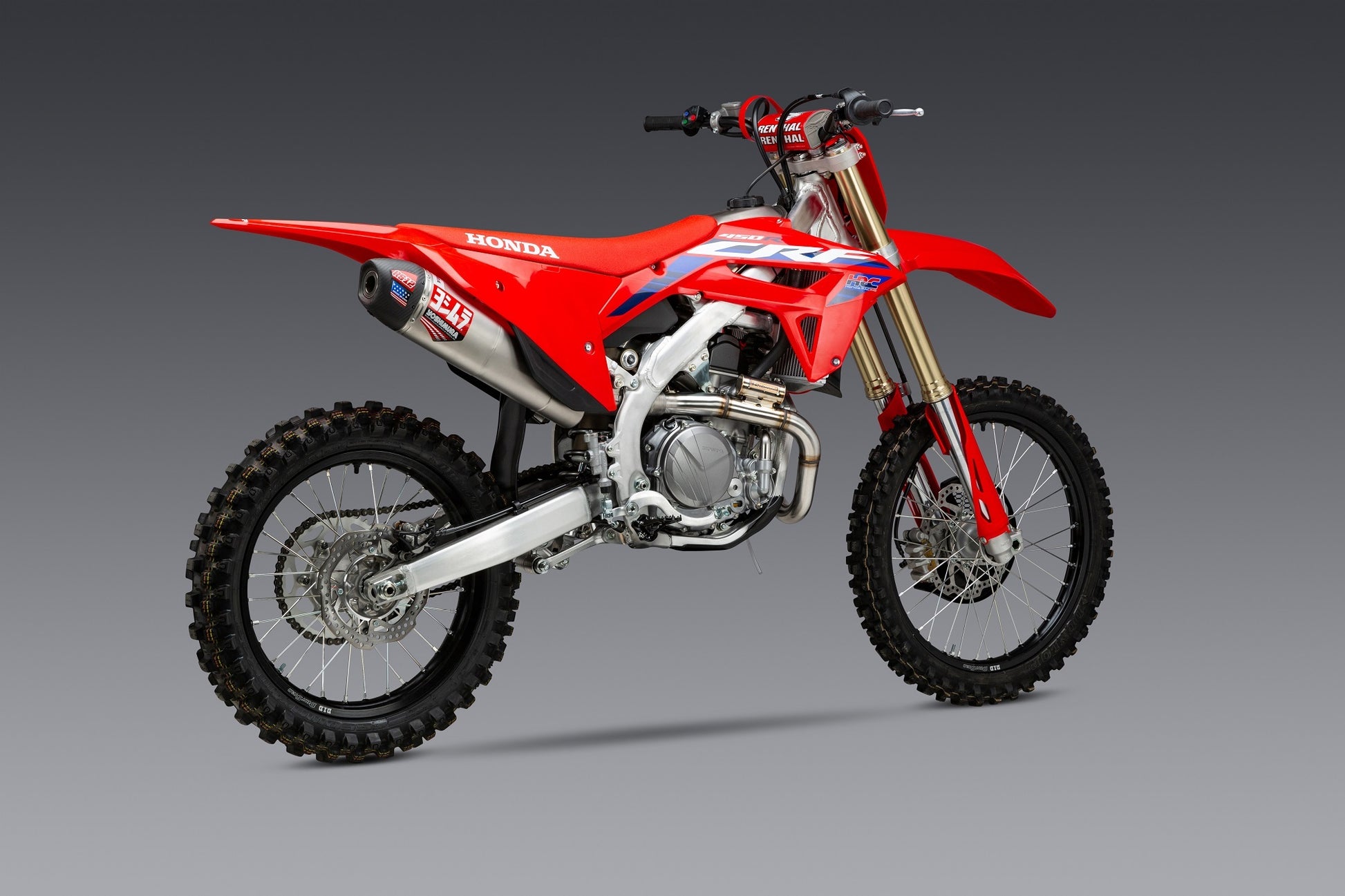 YOSHIMURA RS-12 exhaust system for Honda CRF450 with matte carbon fiber end cap, showcasing sleek stainless steel and exhaust details.