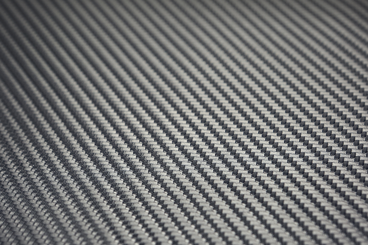 Saddlemens Carbon Seat Cover in black, measuring 54x36 inches, designed for motorcycle seats, with textured carbon fiber pattern.