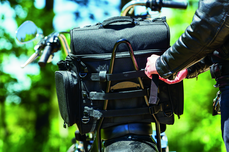 Kuryakyn Momentum Vagabond Bag mounted on motorcycle seat and luggage rack for versatile storage.