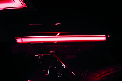 Kuryakyn Tracer Tour Pak side lights with red lens installed on a Harley Davidson touring motorcycle.