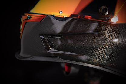 Red ICON Airframe Pro™ helmet in carbon fiber with small size, featuring a sleek aerodynamic design and secure chin strap.