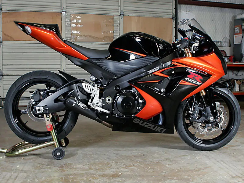 Black M4 GP slip-on exhaust for 2007-2008 Suzuki GSXR1000 from Bill's Exhausts, showing the sleek, cylindrical design.