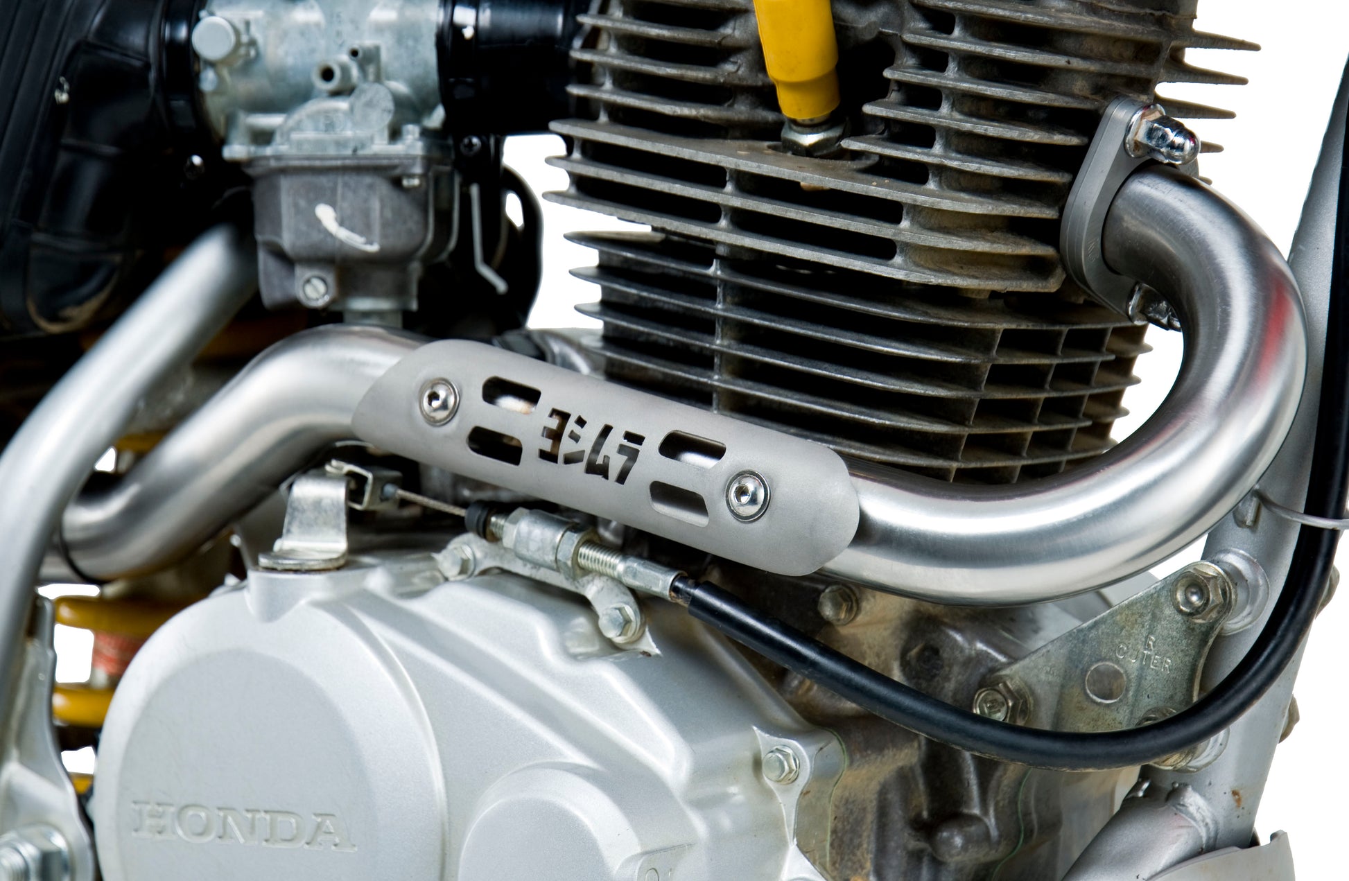 YOSHIMURA RS 2 UTV exhaust system with header, canister, and end cap, showcasing sleek metal components and branding.
