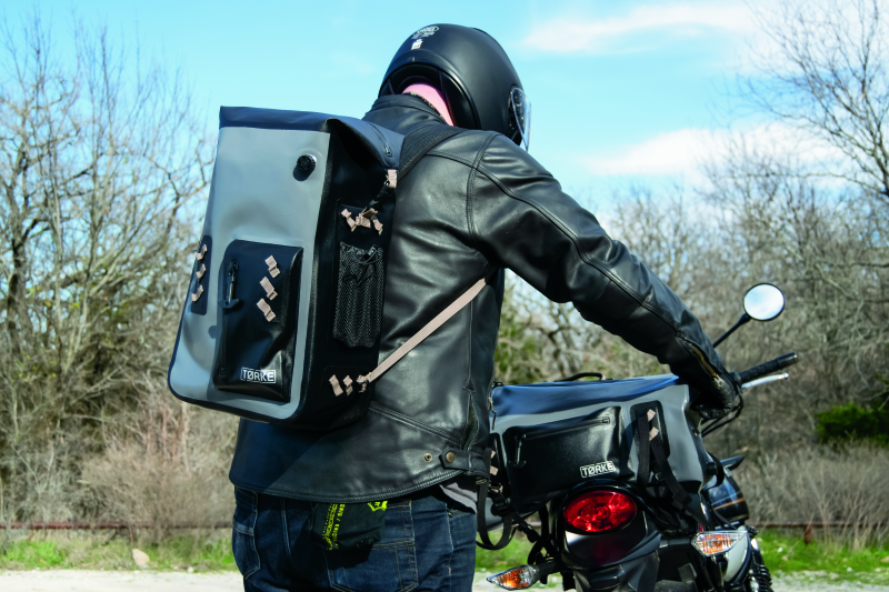 Kuryakyn Torke 25L waterproof motorcycle backpack with reflective logos and versatile storage for riding gear and essentials