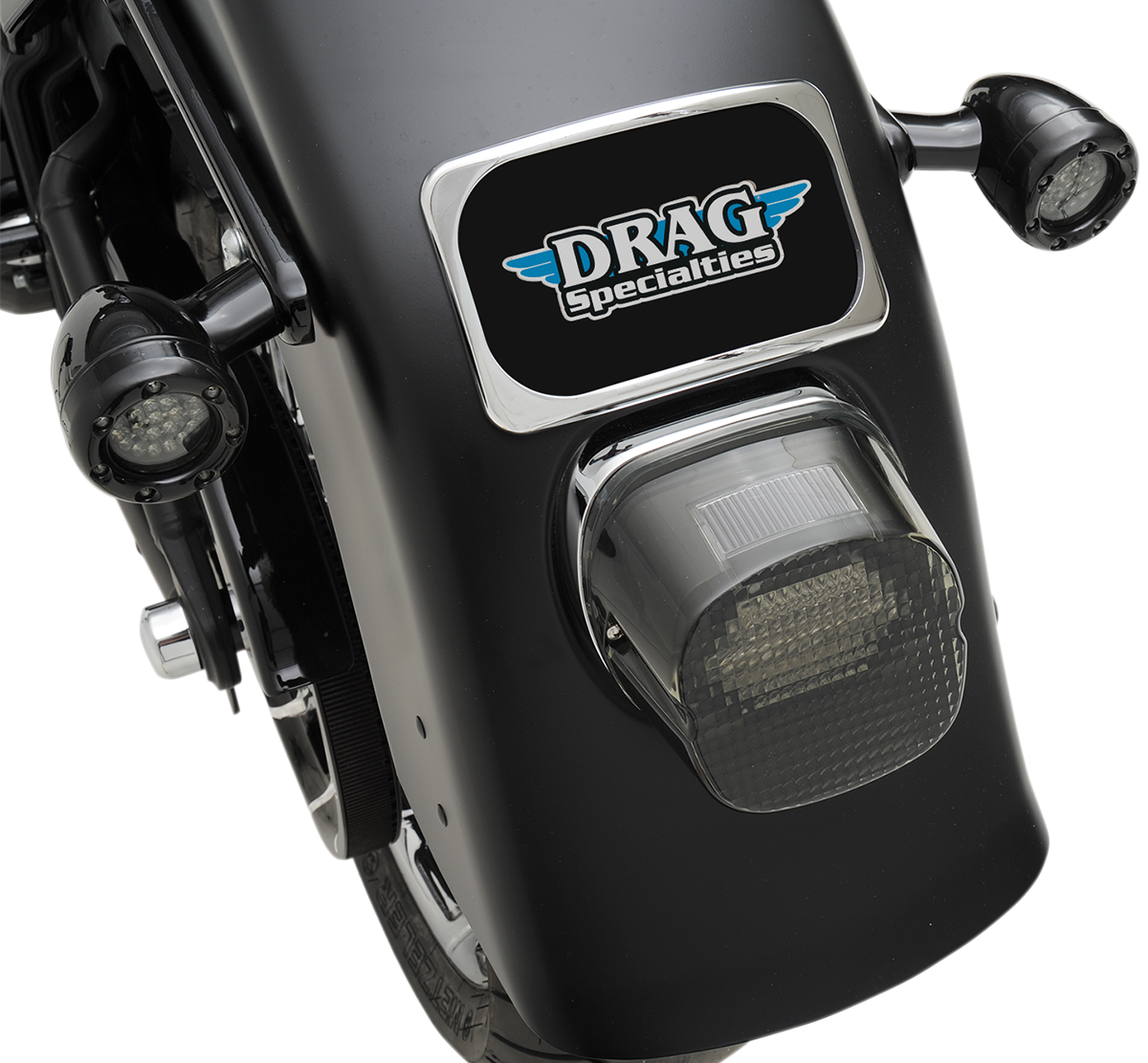 Chrome 3-hole license plate mount for fenders up to 8 inches wide, designed by DRAG SPECIALTIES, shown on a motorcycle.