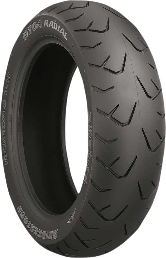 Bridgestone Exedra G704 rear motorcycle tire 180/60R16 with 74H load index and model 70627, showing tread pattern and sidewall details.