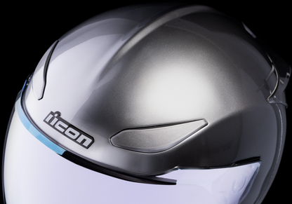 Icon Domain Cornelius helmet in silver, large size, with aerodynamic design and secure chin strap, showcasing the sleek helmet profile.