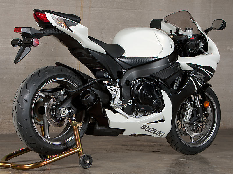 Black M4 GP slip-on exhaust for GSXR600/750 motorcycle, showing the sleek, compact design with exhaust pipe and branding details.