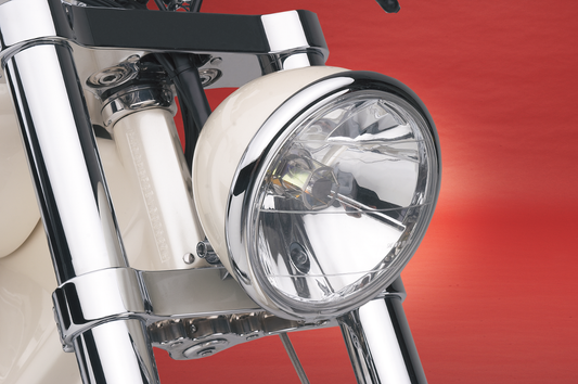 Drag Specialties 7-inch headlight with running light for motorcycles, featuring a durable chrome finish and clear lens.