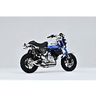 Over Racing spiral full titanium exhaust installed on Honda Monkey 125 and DAX 125 motorcycle, showcasing sleek metallic design.