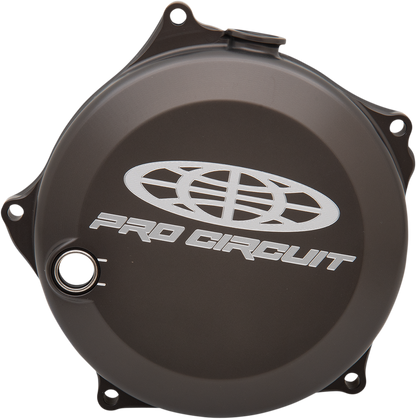 PRO CIRCUIT clutch cover for Kawasaki and Suzuki motorcycles, durable metal part with mounting holes and branding details.