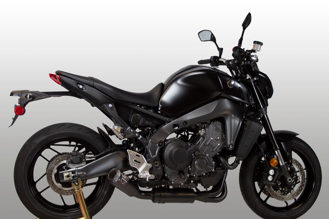 Black full M4 exhaust system for Yamaha MT-09/SXR900 2021-2026, side view showing sleek all-black design and mounting details.