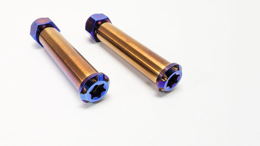 Warp9Racing titanium footpeg pivot pin for motorcycle foot pegs, showcasing a sleek, durable metal component with precise machining.