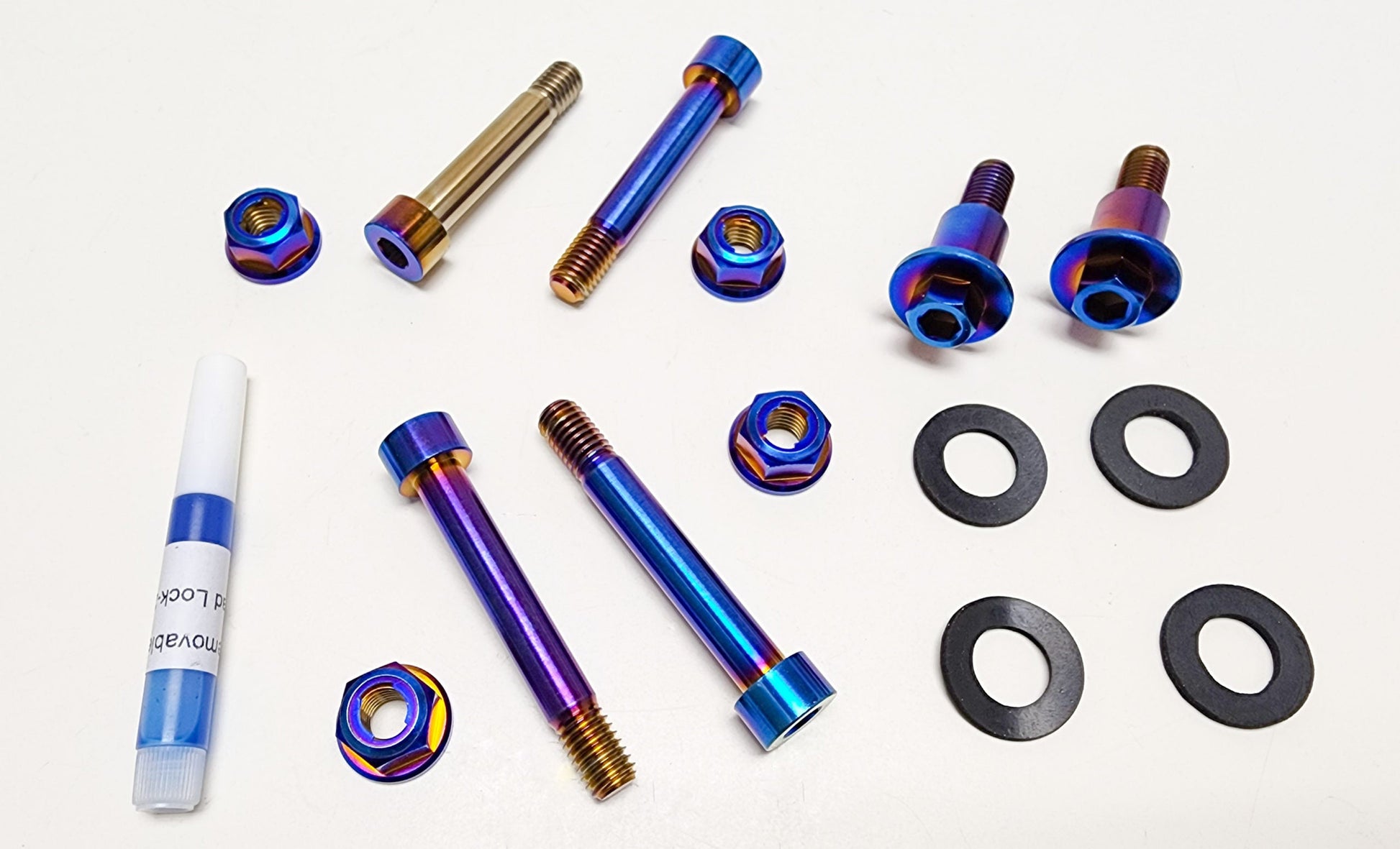 Surron Light Bee linkage bolt kit by Warp9Racing, featuring metal bolts and components for electric bike suspension and frame.