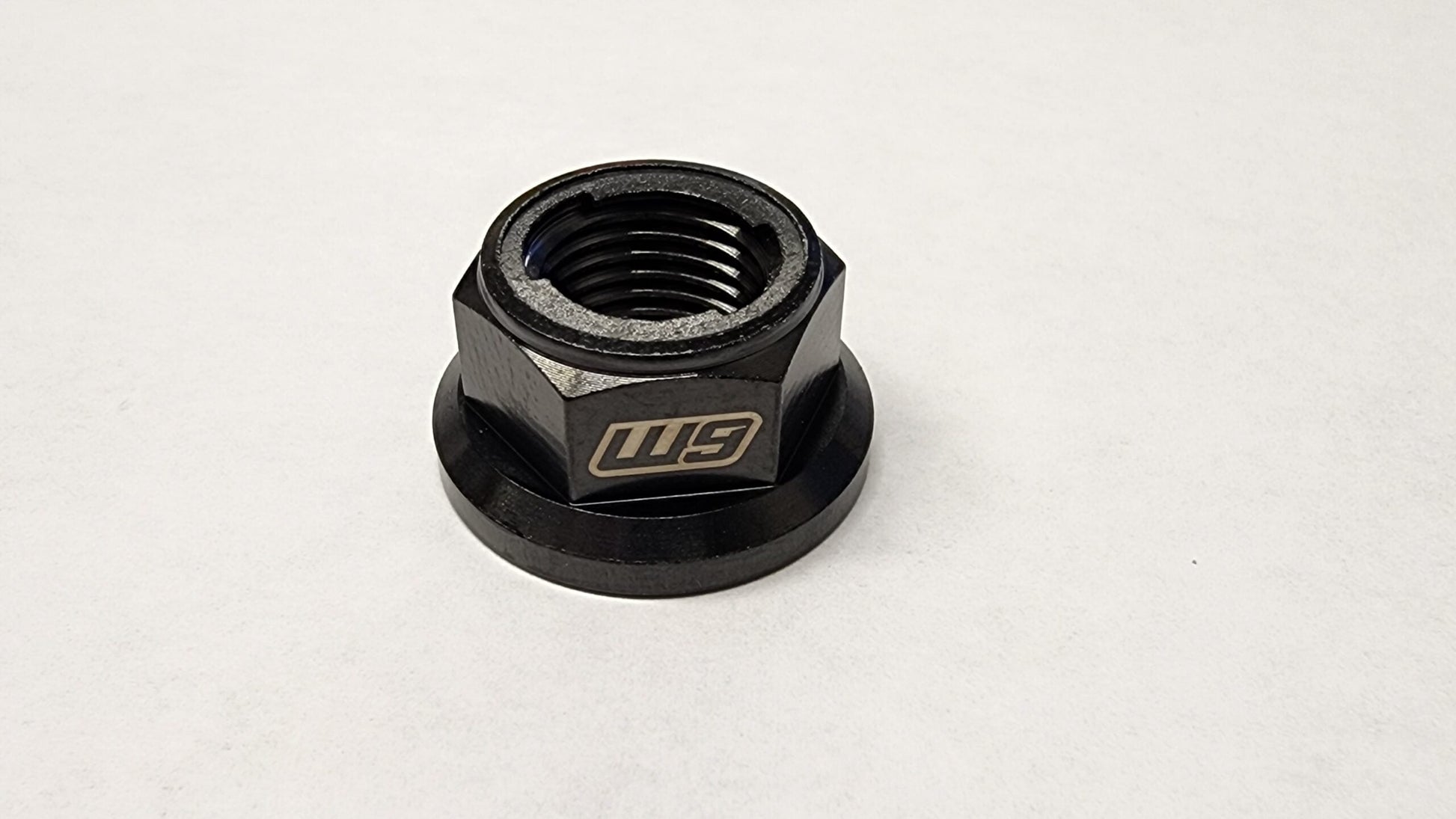 Warp 9 Titanium rear axle replacement nut for Talaria electric bike, featuring lightweight, durable design by Warp9Racing.