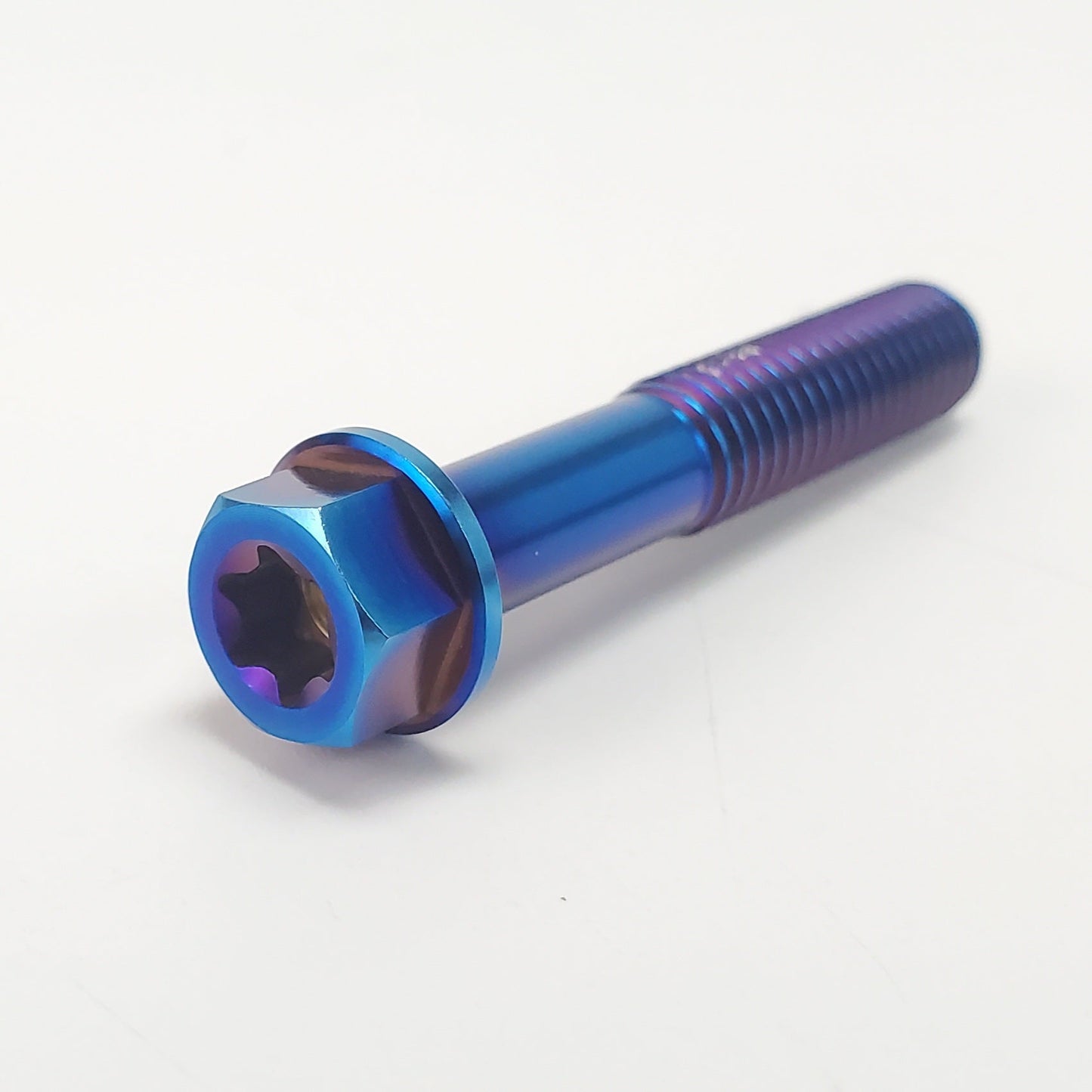 Set of Warp9Racing titanium M8 bolts with threaded shafts and hex heads, arranged on a white surface.