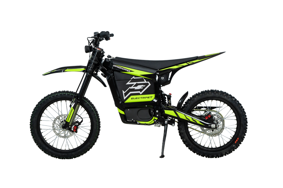 Howling Moto Grasshopper SE electric dirt bike with 72V 60Ah battery and 12.5kW mid-drive motor, shown on rugged terrain.