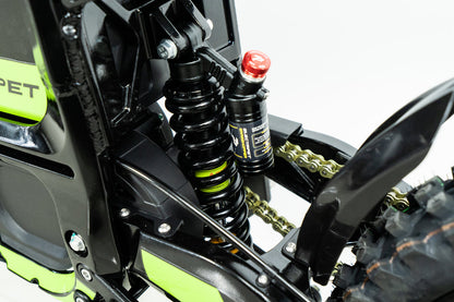 Howling Moto Grasshopper SE electric dirt bike with 72V 60Ah battery and 12.5kW mid-drive motor, shown outdoors on rough terrain.