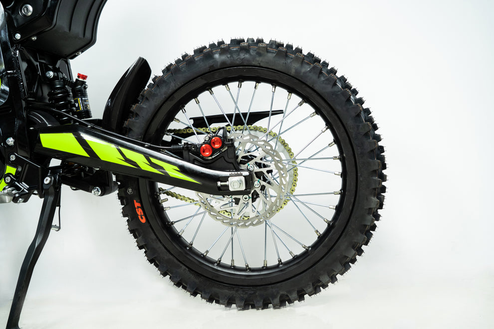 Howling Moto Grasshopper SE electric dirt bike with 72V 60Ah battery and 12.5kW mid-drive motor, shown on a trail.