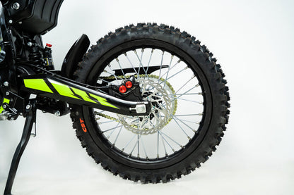 Howling Moto Grasshopper SE electric dirt bike with 72V 60Ah battery and 12.5kW mid-drive motor, shown on a trail.