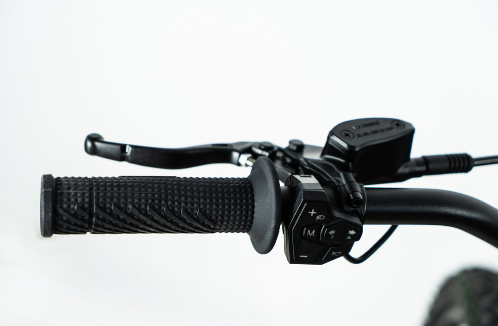 Howling Moto Grasshopper SE electric dirt bike with 72V 60Ah battery and 12.5kW mid-drive, shown on rugged terrain.