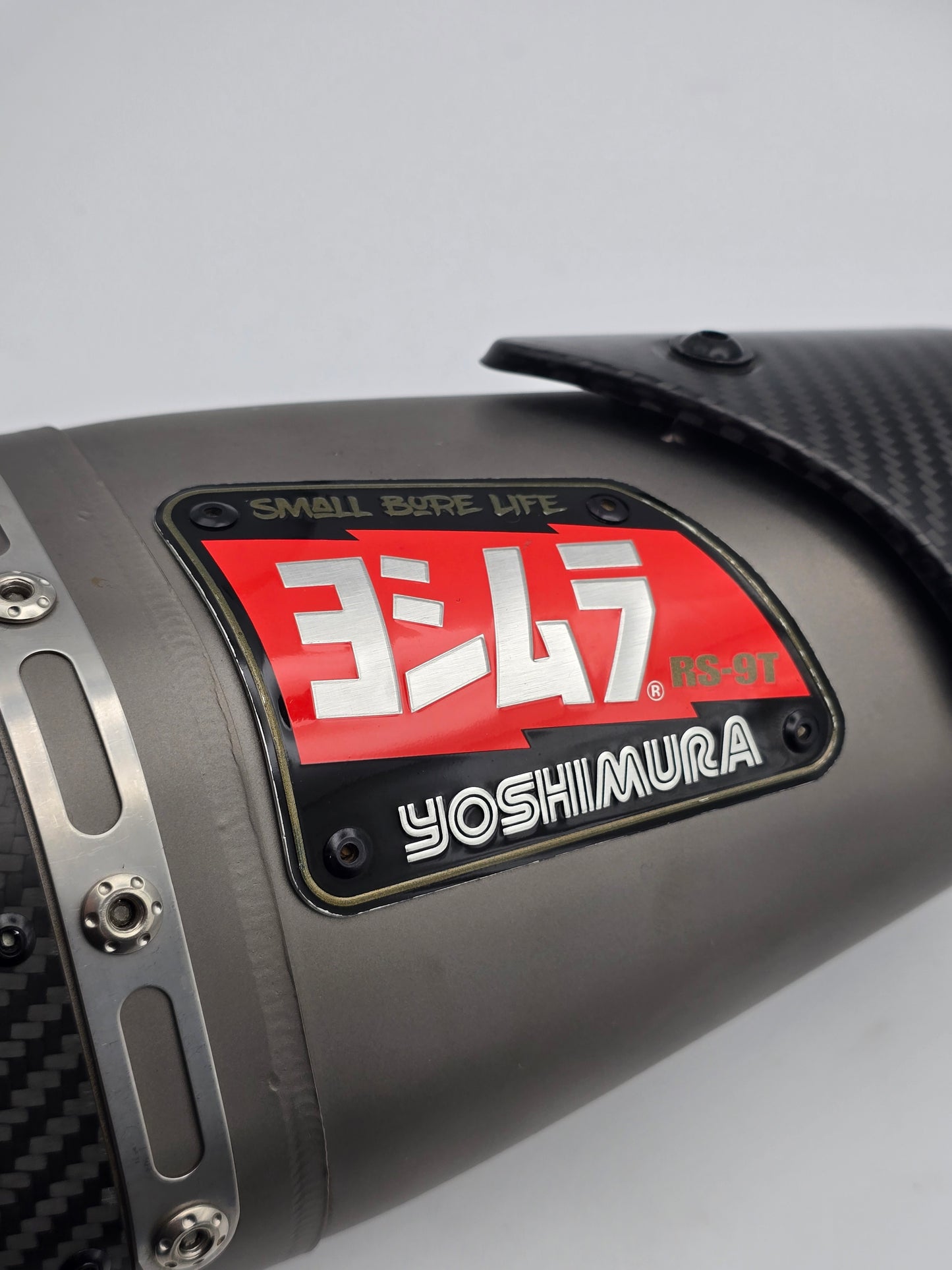 Used Yoshimura RS-9T titanium motorcycle exhaust system for Honda Grom 2014-2020, showing the full exhaust with titanium finish.