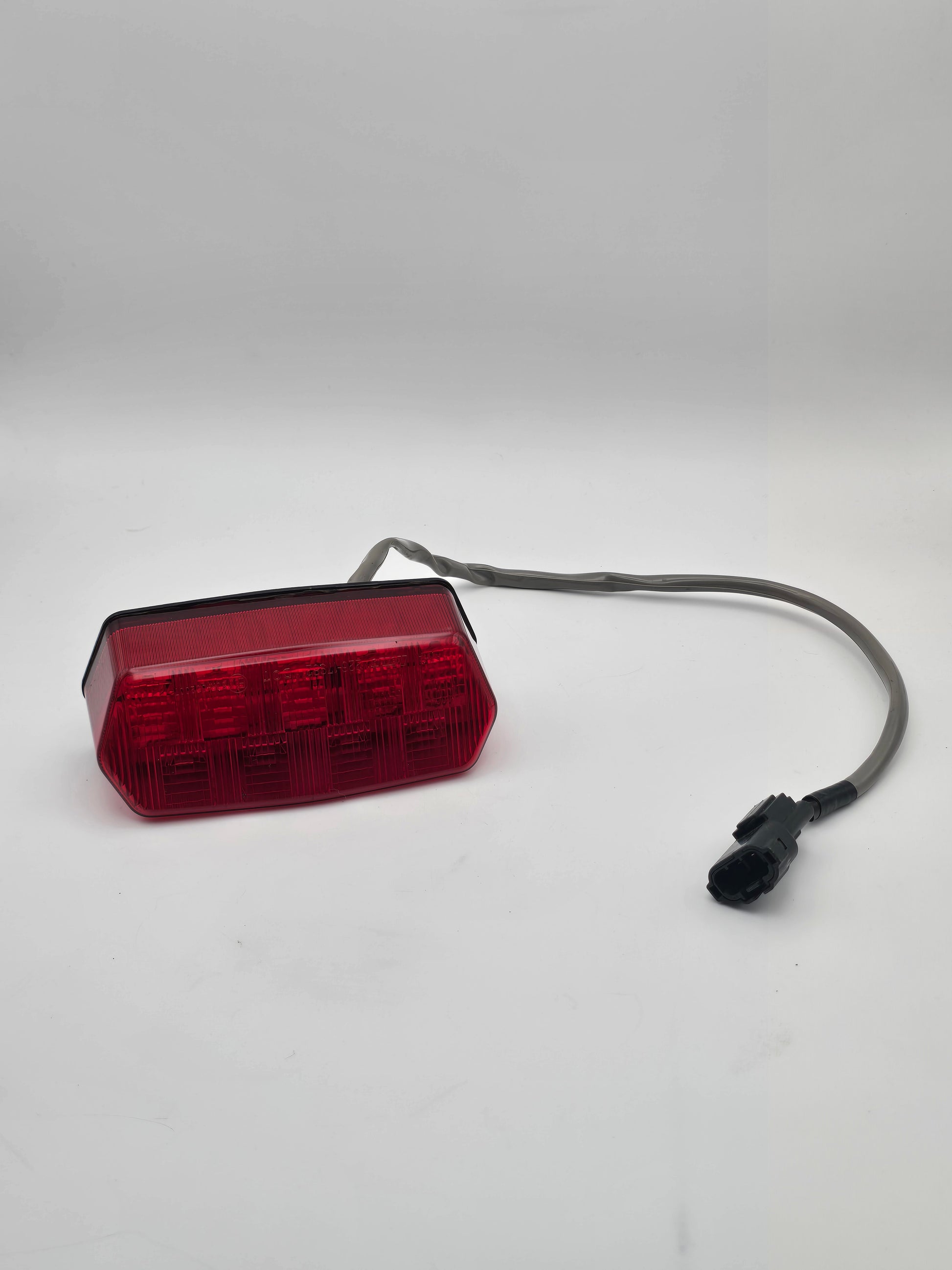 Used Honda Grom OEM tail light for 2014-2015 models, motorcycle lighting part in good condition.