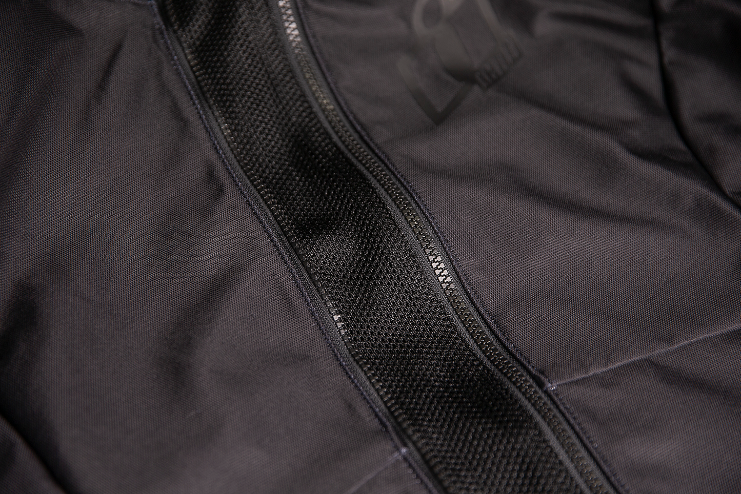 Black ICON Women's Airform™ Jacket displayed on a hanger, showcasing its lightweight, stylish design and sleek fit.