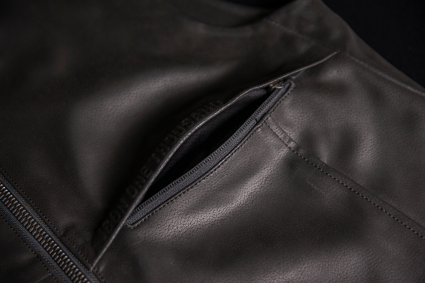 ICON Backlot vest in black with relaxed fit, featuring Ax® Laredo synthetic chassis, size L/XL, displayed on a hanger.