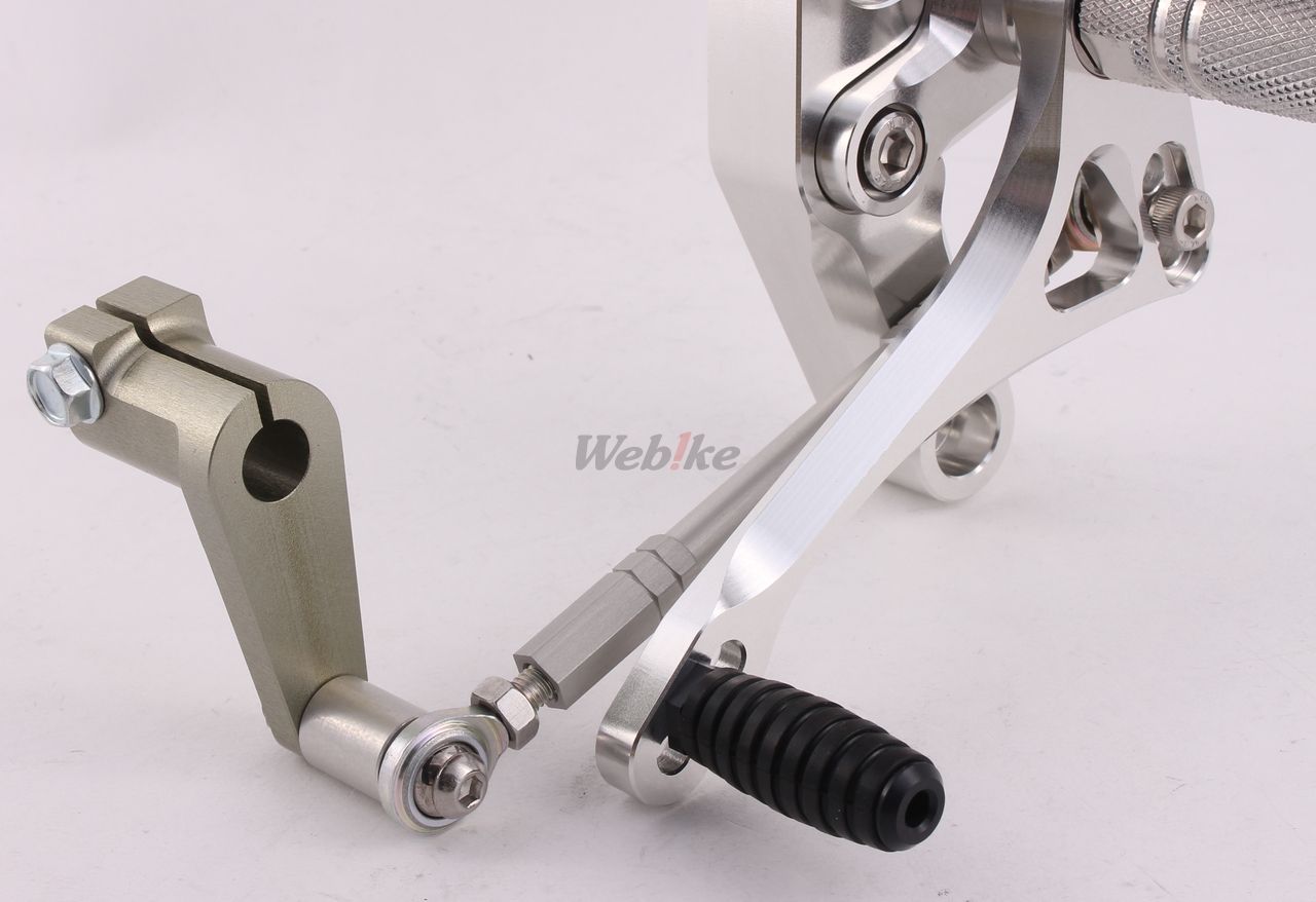 Over Racing 4-position rearsets for Honda Grom motorcycle, featuring adjustable footpeg and brake lever, black metal finish.