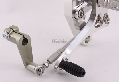 Over Racing 4-position rearsets for Honda Grom motorcycle, featuring adjustable footpeg and brake lever, black metal finish.
