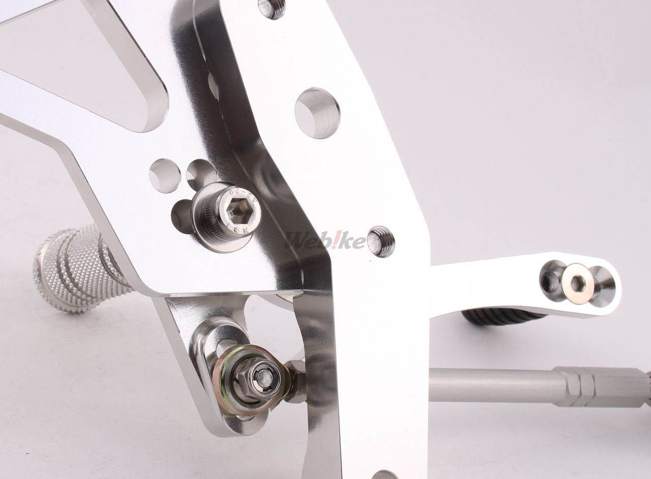 Over Racing rearsets with four adjustable positions for Honda Grom, featuring durable metal construction and custom mounting points.