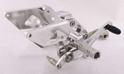 Over Racing rearsets with four adjustable positions for Honda Grom motorcycle, shown installed on the bike.